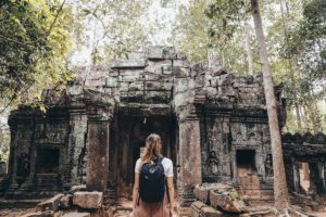 Girl looks at temple in Angkor Wat complex, Siem Reap