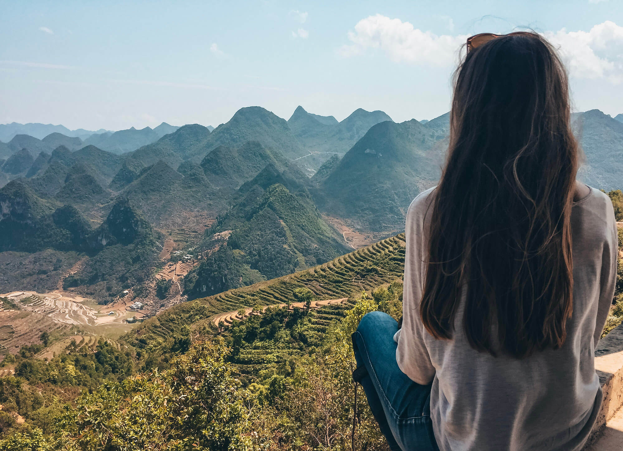 Girl looks out at rice terraces in northern Vietnam