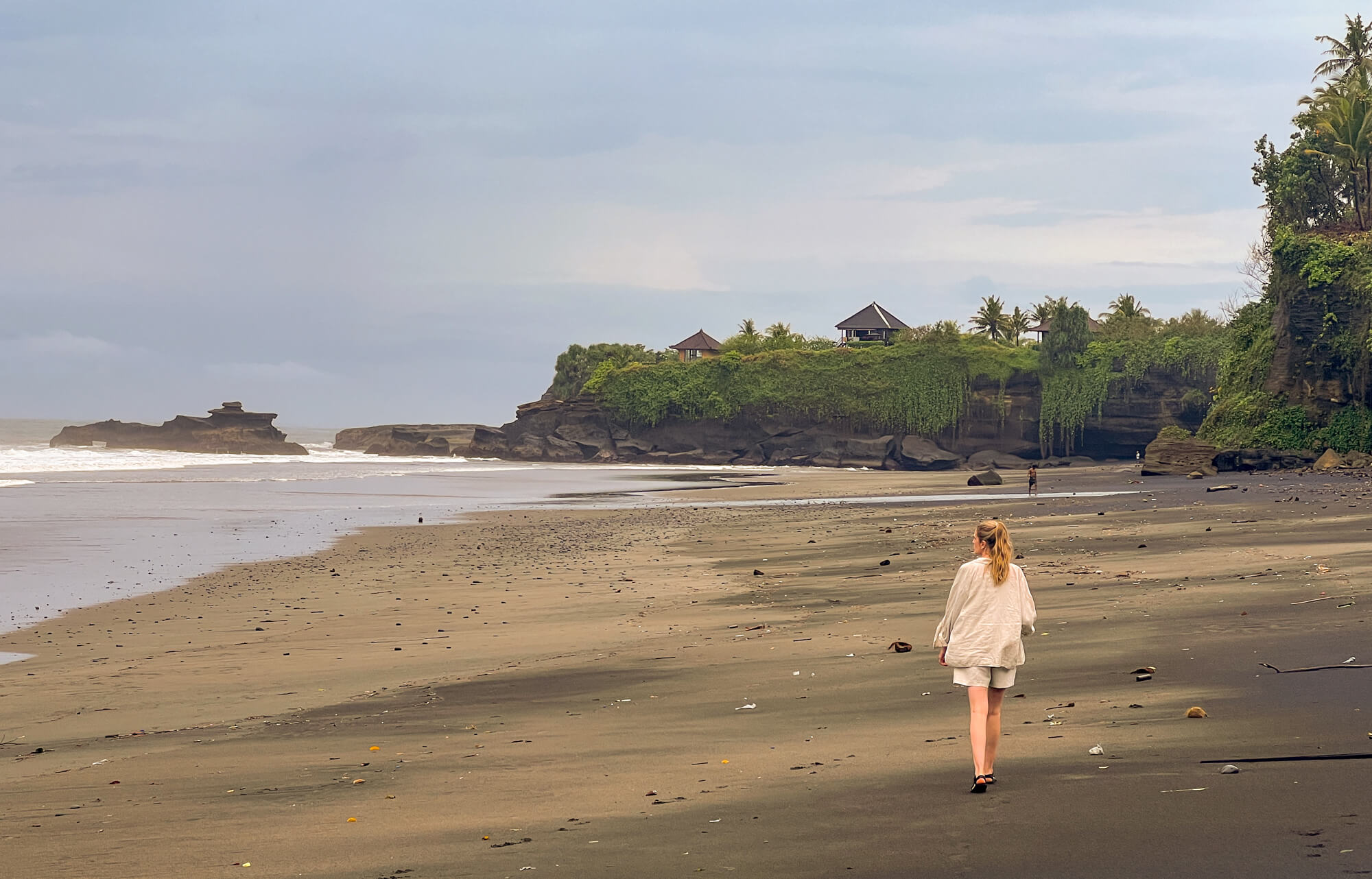 person walks along Balian Beach in Bali